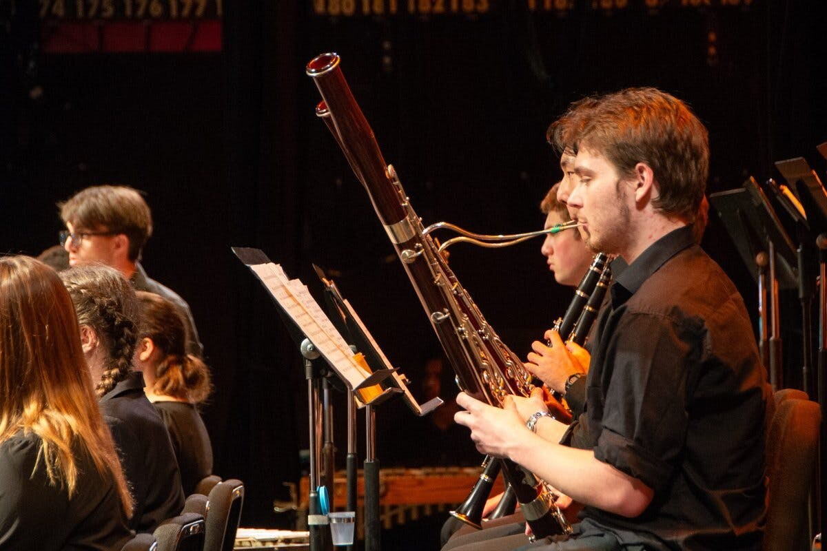 Closeup of a bassonist with orchestra