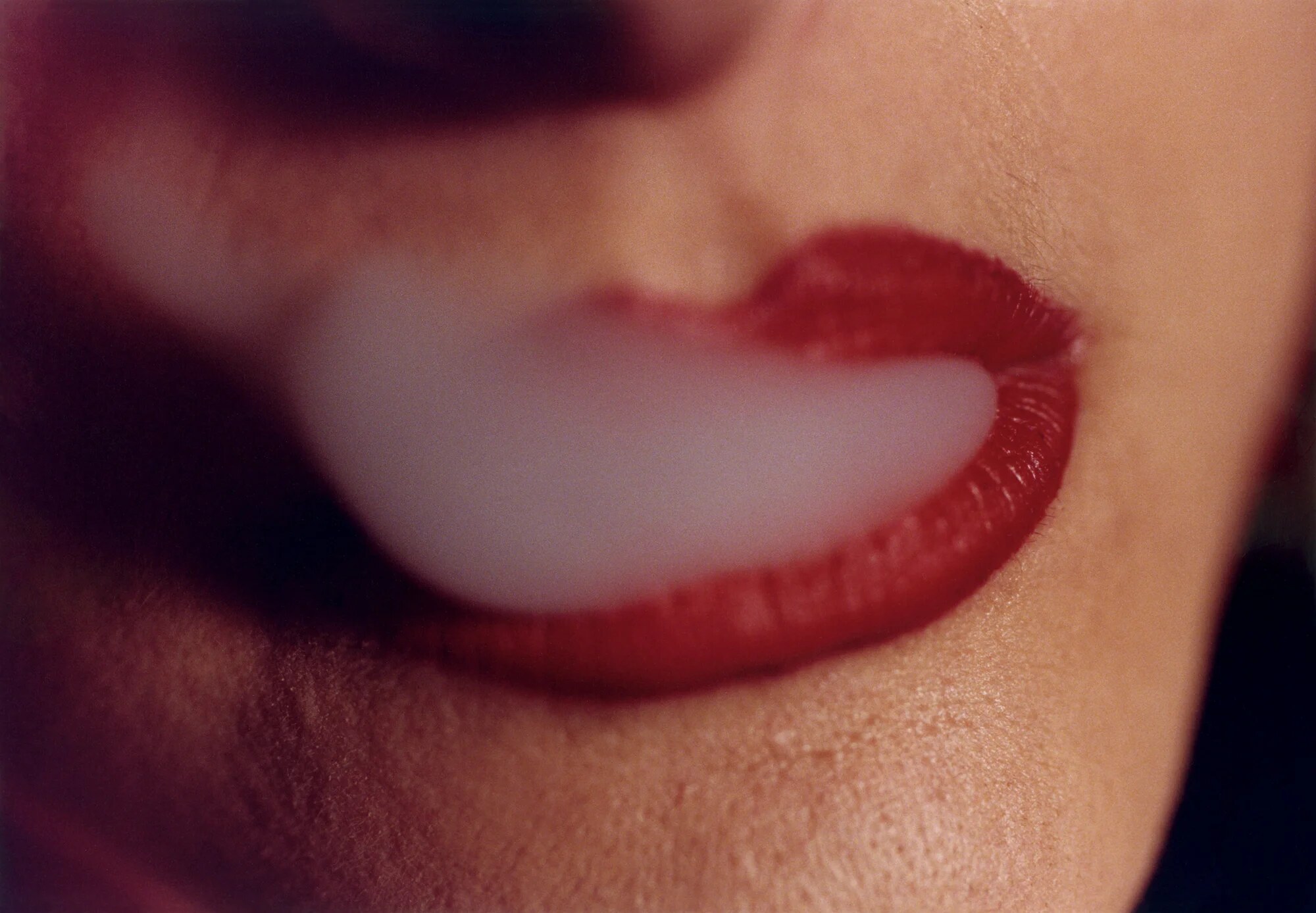 David Lynch photograph of red lips releasing a cloud of smoke, from the LA exhibition at Pace Gallery.