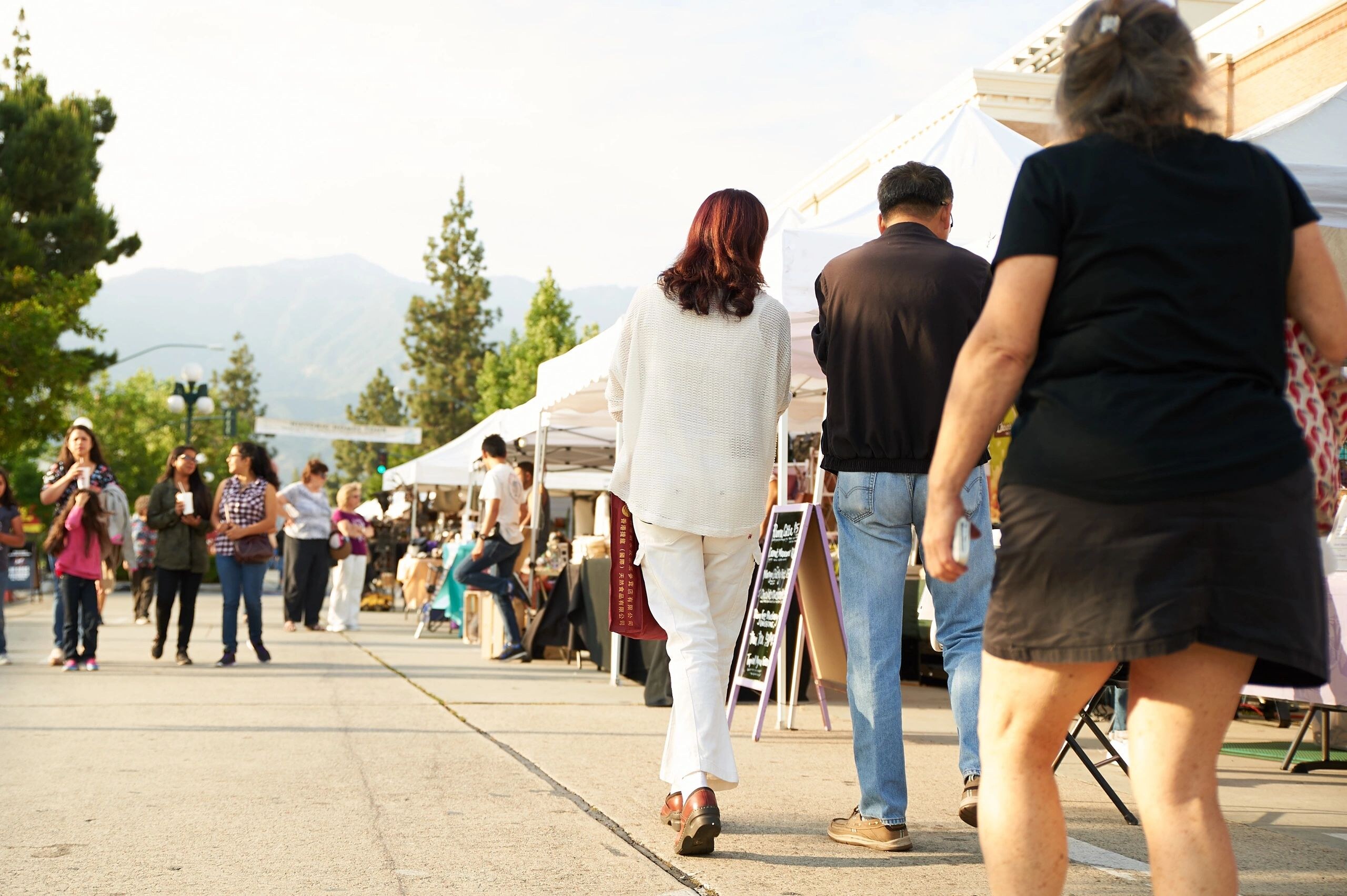 People browsing outdoor vendors at the Monrovia Street Fair and Market