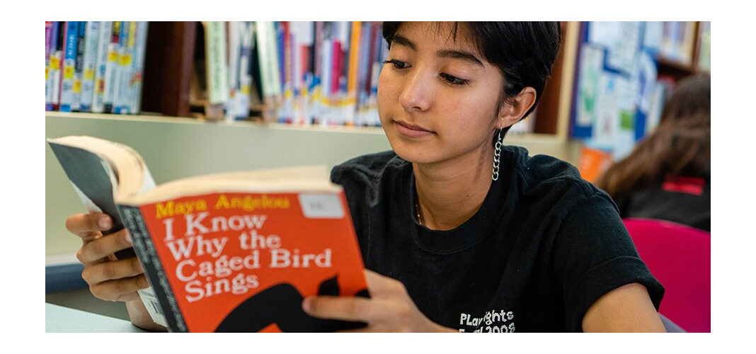 Teen reader holding an open book, the official image for LAPL's Banned Books Celebration