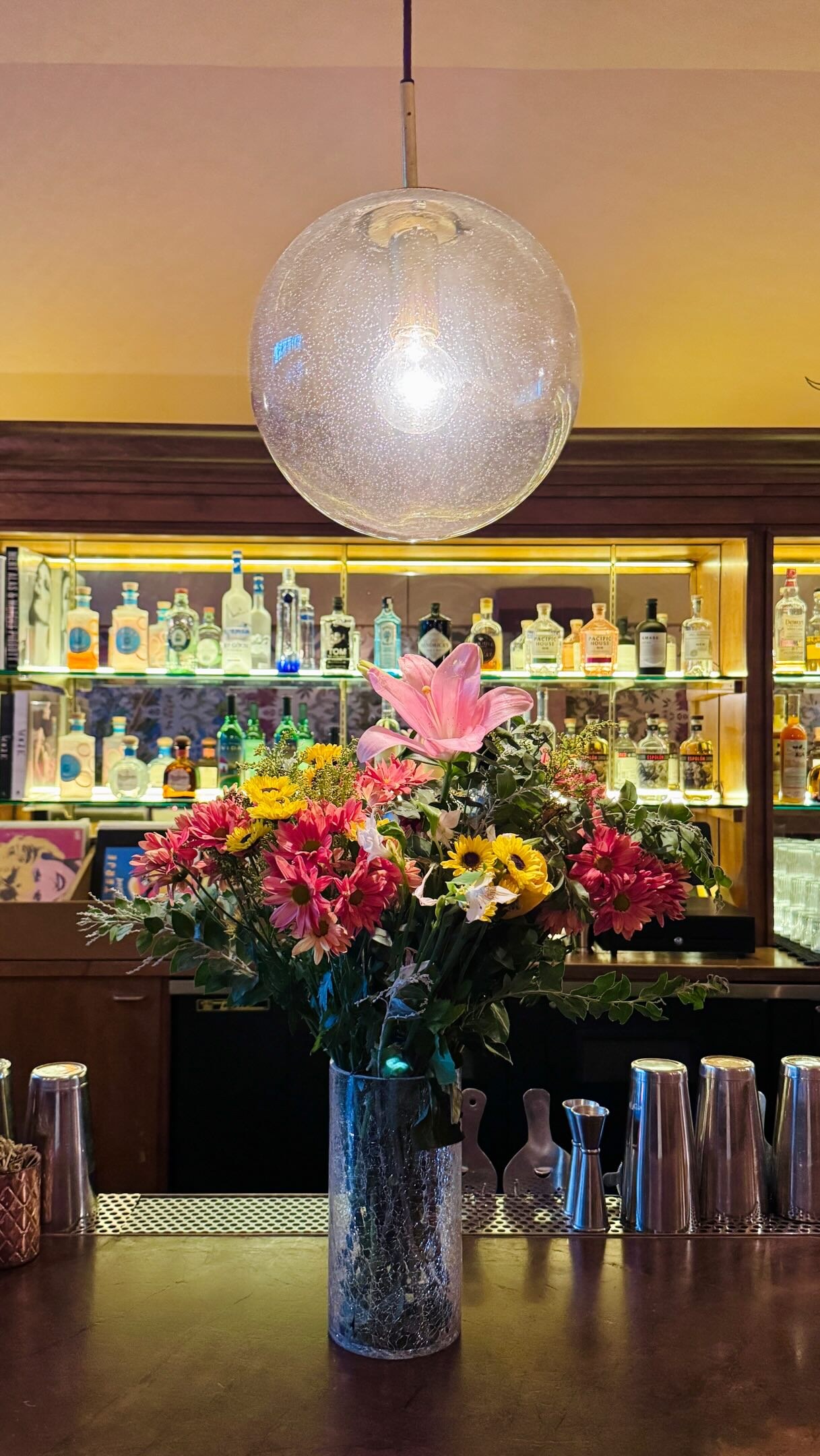 Flowers on the bar beneath a glowing lamp at Bar Franca for the weekly We Got the Jazz series.
