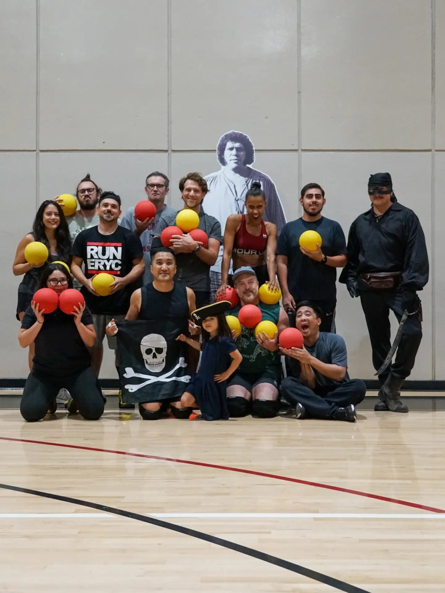 Eagle Rock Yacht Club dodgeball players posing together in a recreation-center gym