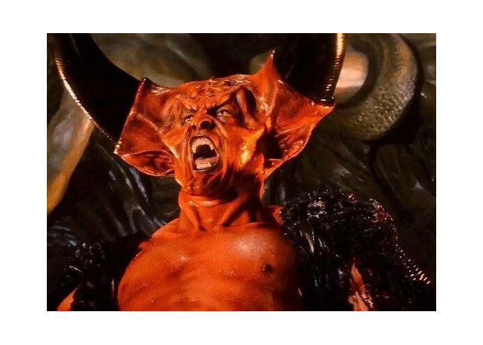Tim Curry in red prosthetic makeup and black horns as the Lord of Darkness in Legend.