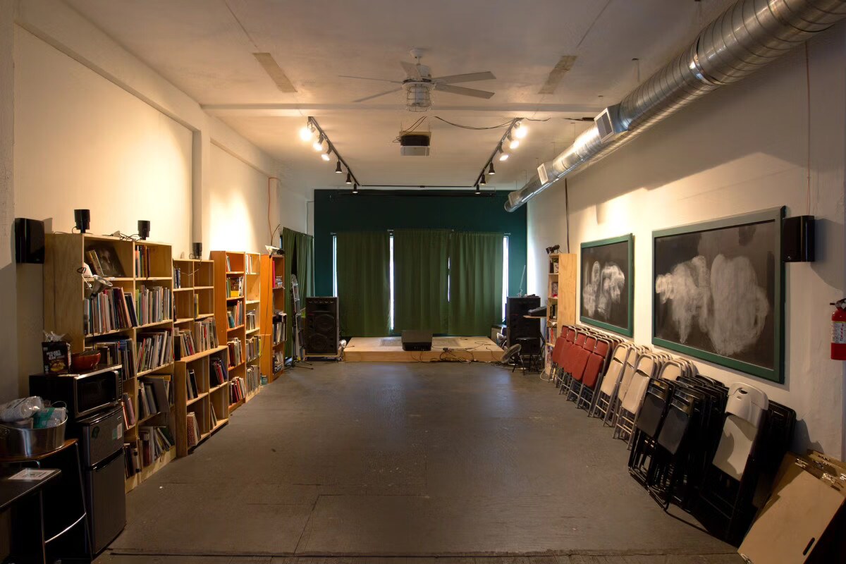 Bookshelves and the event space at Heavy Manners Library.