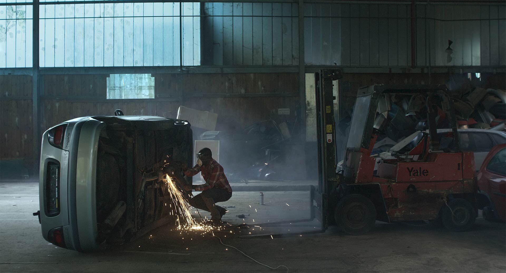 Mechanic at work in a still from Movements of a Nearby Mountain