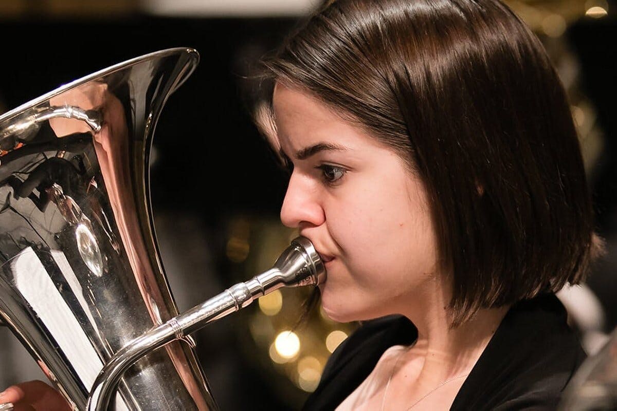 Closeup of a young woman performing on a tuba