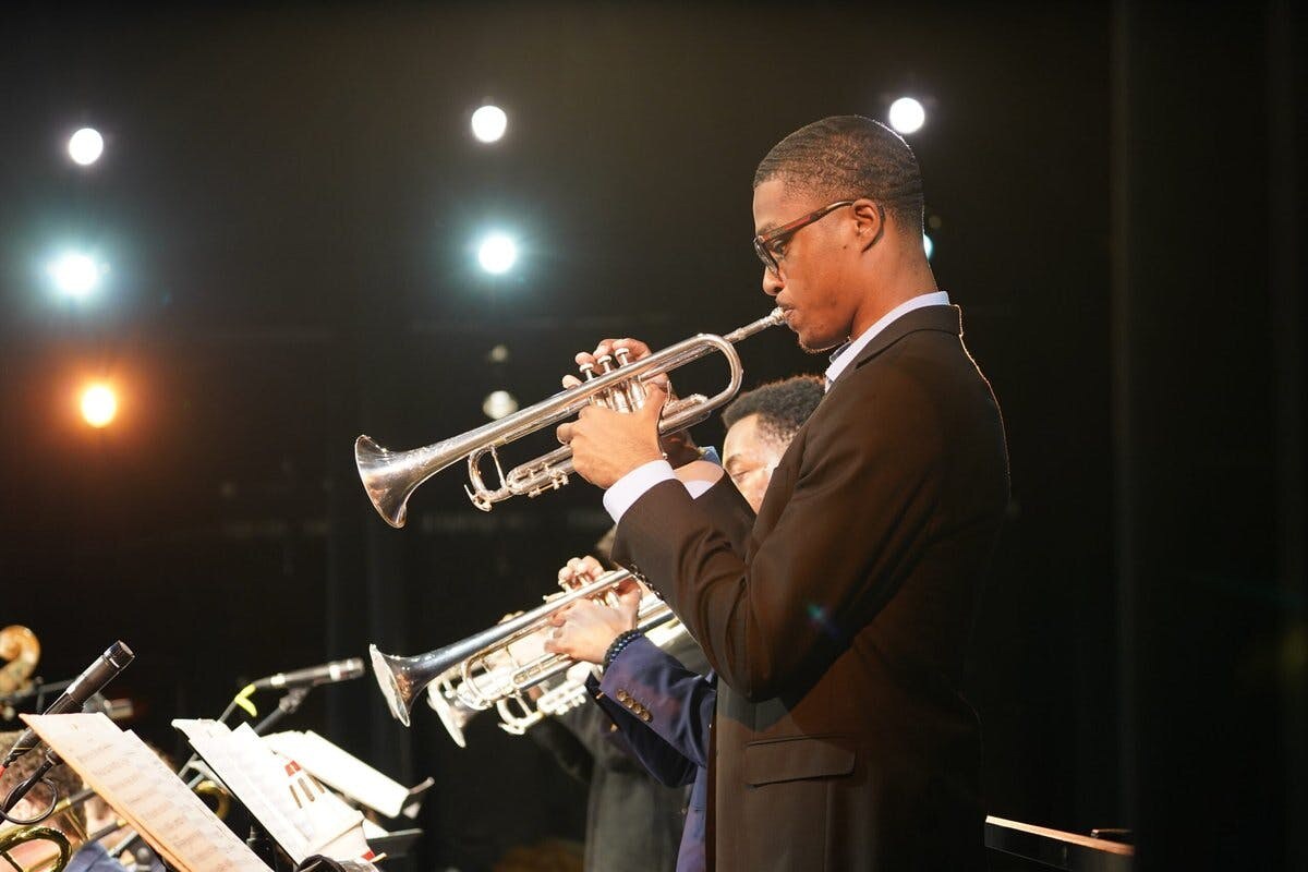 A trumpet player performs a solo with an orchestra