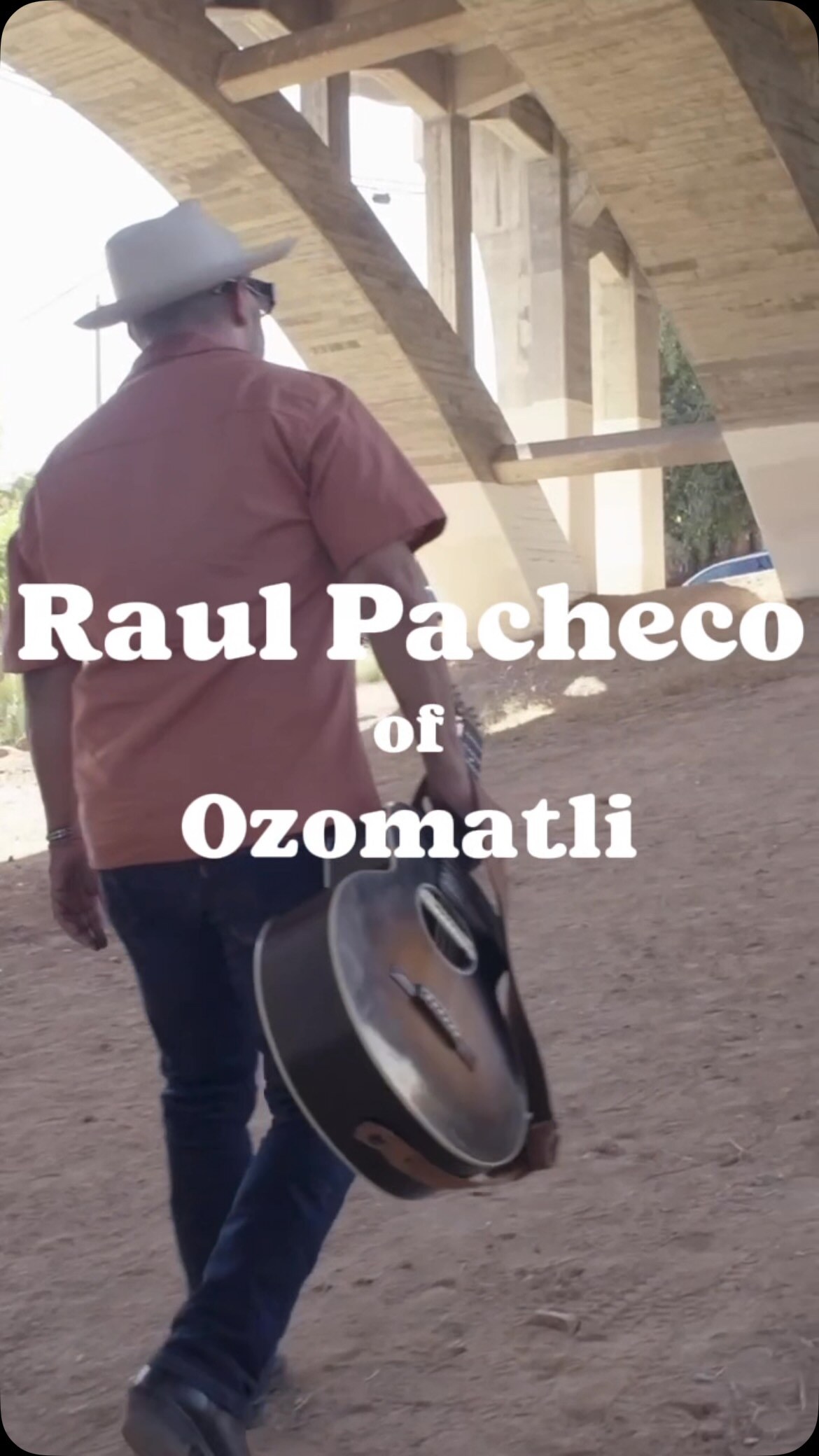 Raul Pacheco of Ozomatli carrying an instrument in the Man Boy Brown announcement video.