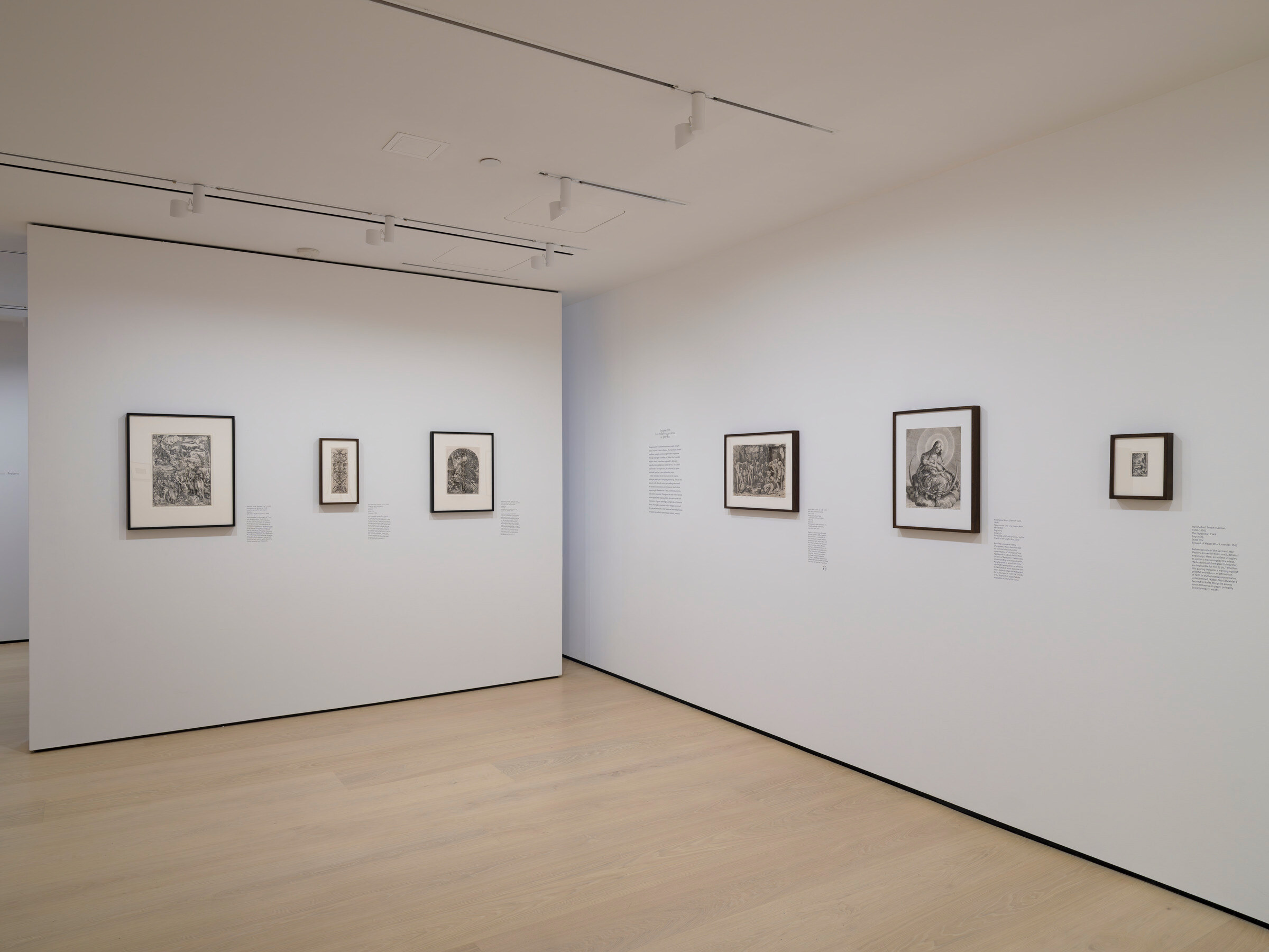 Gallery with framed works on paper mounted on the wall