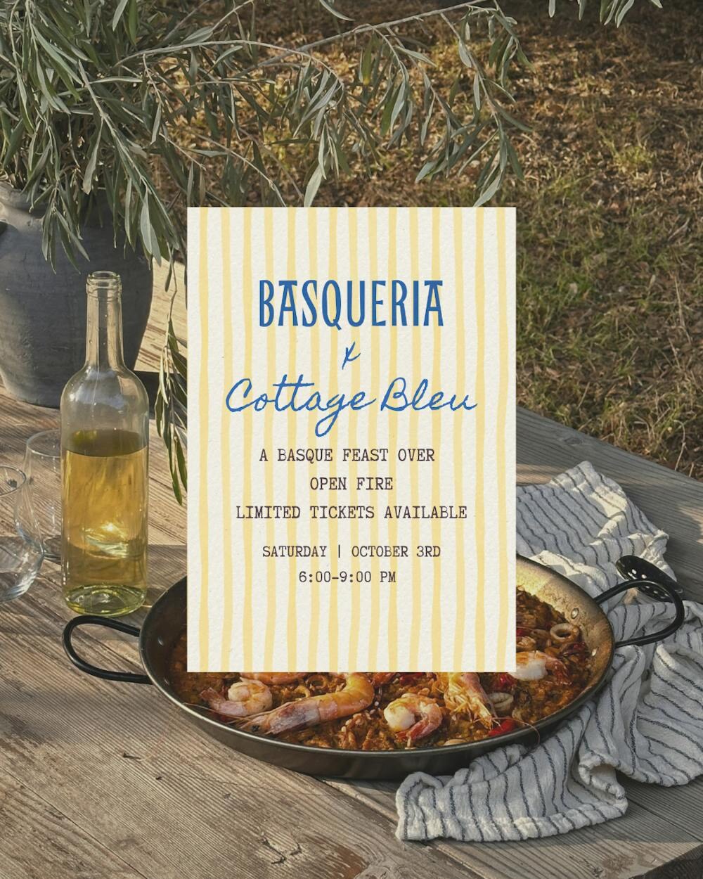 Basqueria Feast at Cottage Bleu flyer set over an outdoor paella table.