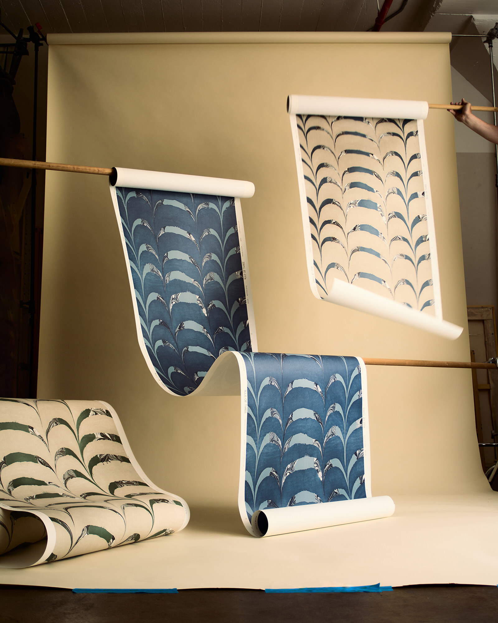 Marbled textiles and wallpaper displayed at Rule of Three Studio.